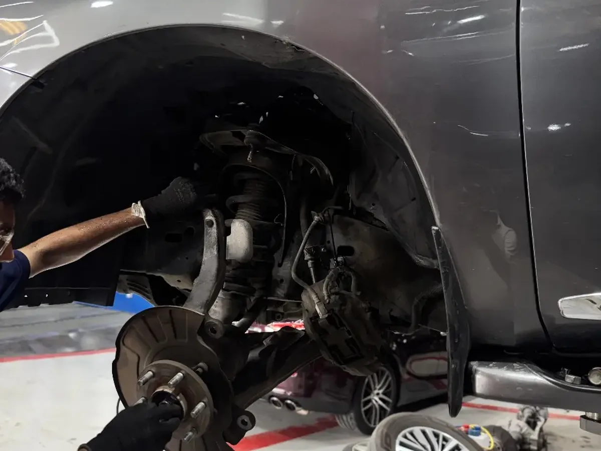 Suspension and brake work underway with the wheel removed at the Musaffah workshop