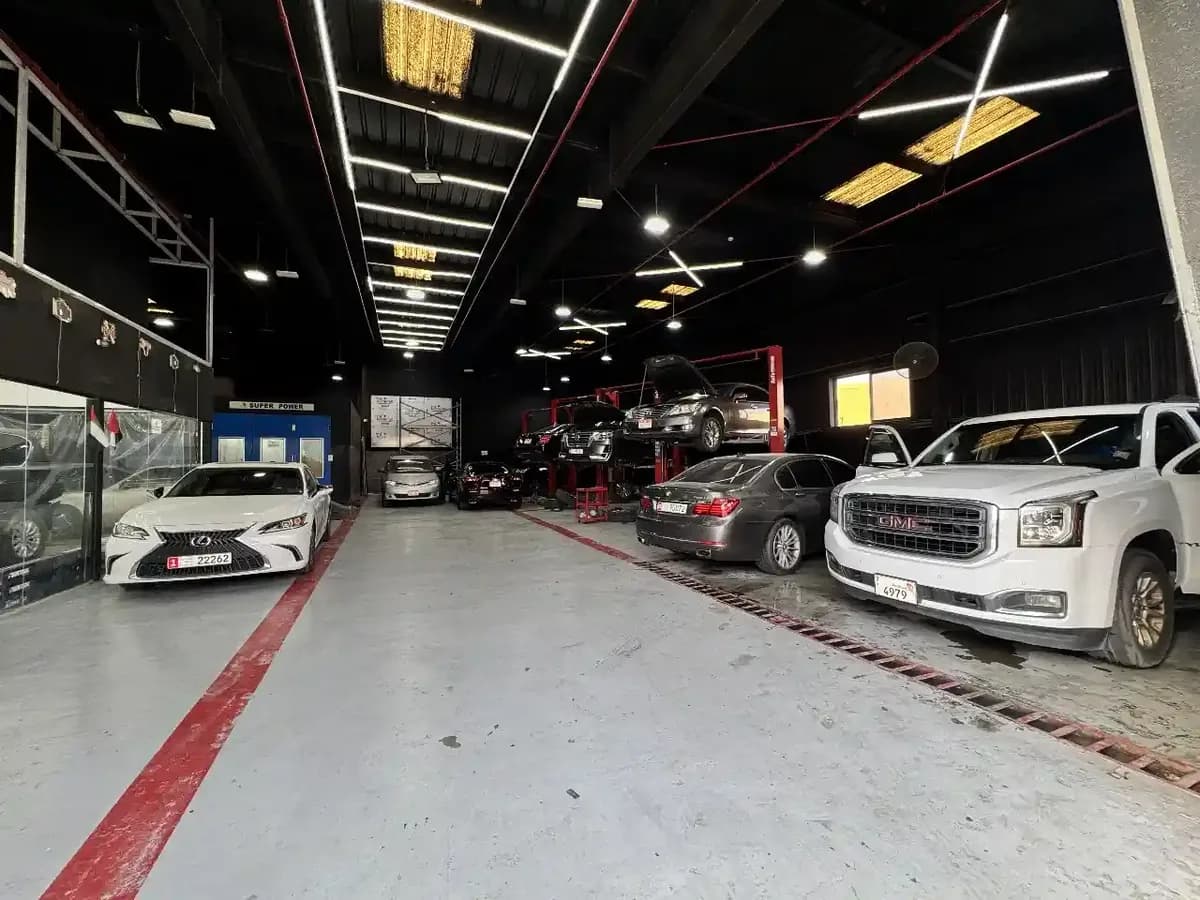 Vehicles on the ramps inside the Zenfo Auto Services workshop in Musaffah